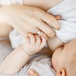 Close up of intimate moment mother lactating her newborn son. Scene of innocence and protection. Family, motherhood and lifestyle concept. Close up of intimate moment mother lactating her newborn son. Scene of innocence and protection. Family, motherhood and lifestyle concept