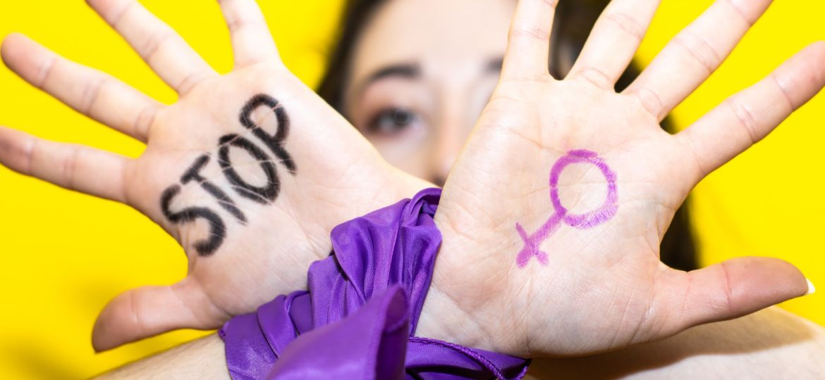 Woman showing stop sign and female symbol on hands for women's day
